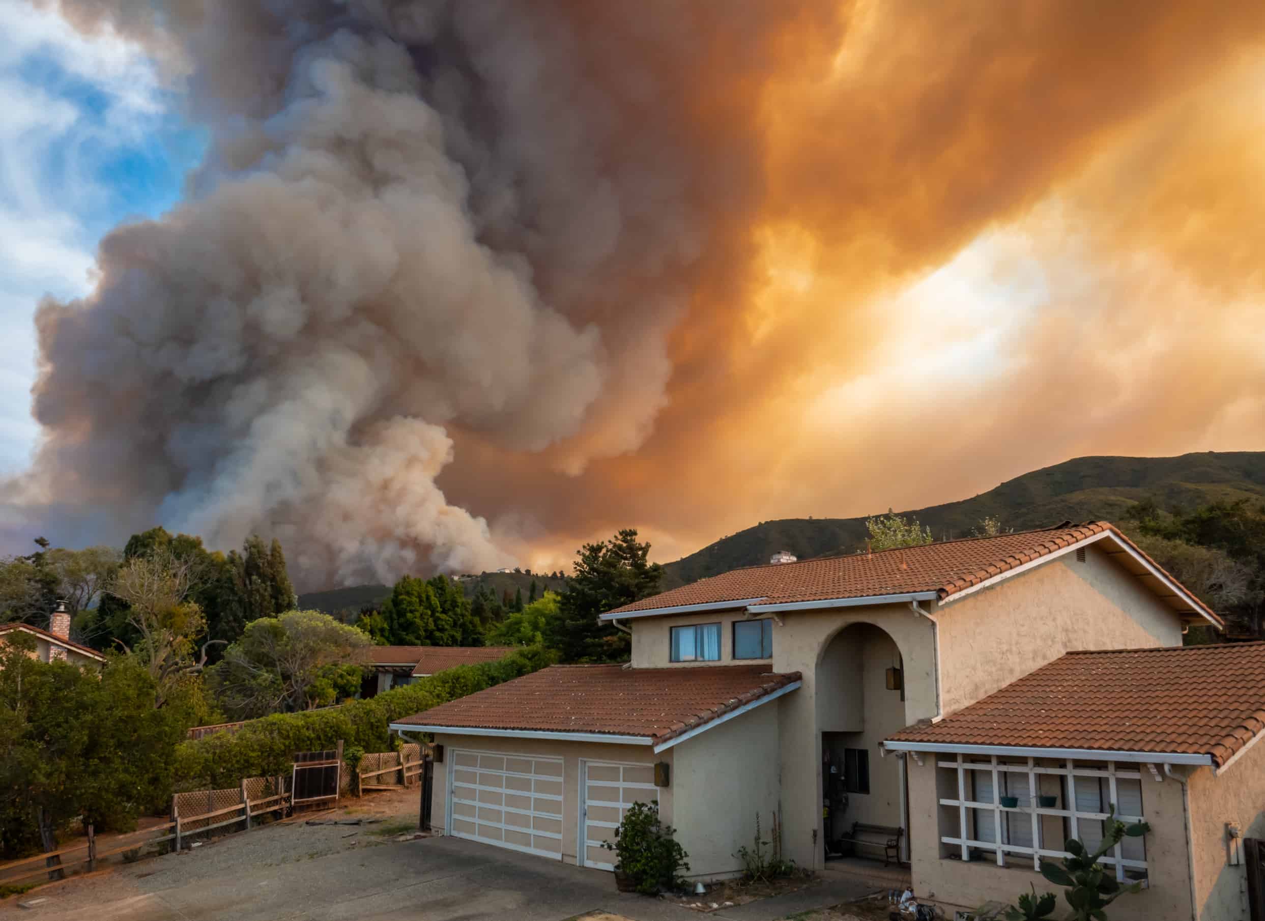 House with wildfire in background
