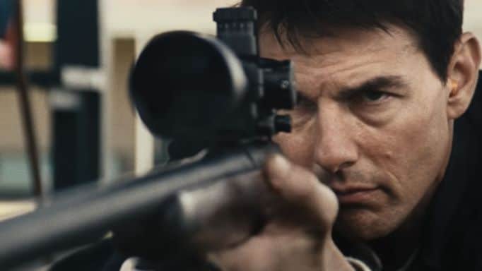 Tom Cruise holding a gun.
