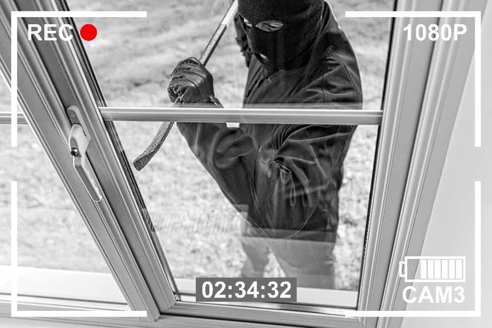 Burglar prying open a door