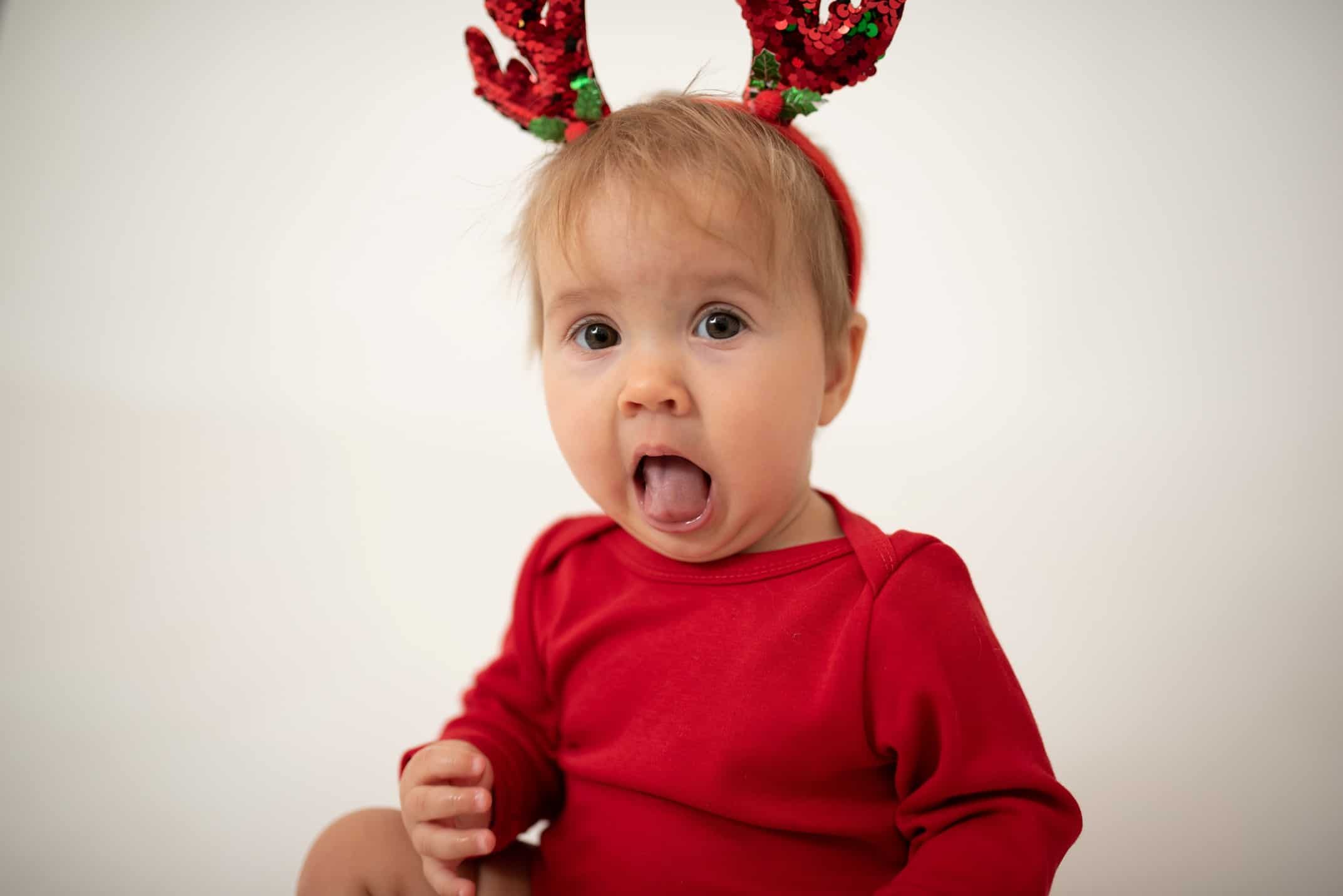 A baby in Christmas clothes