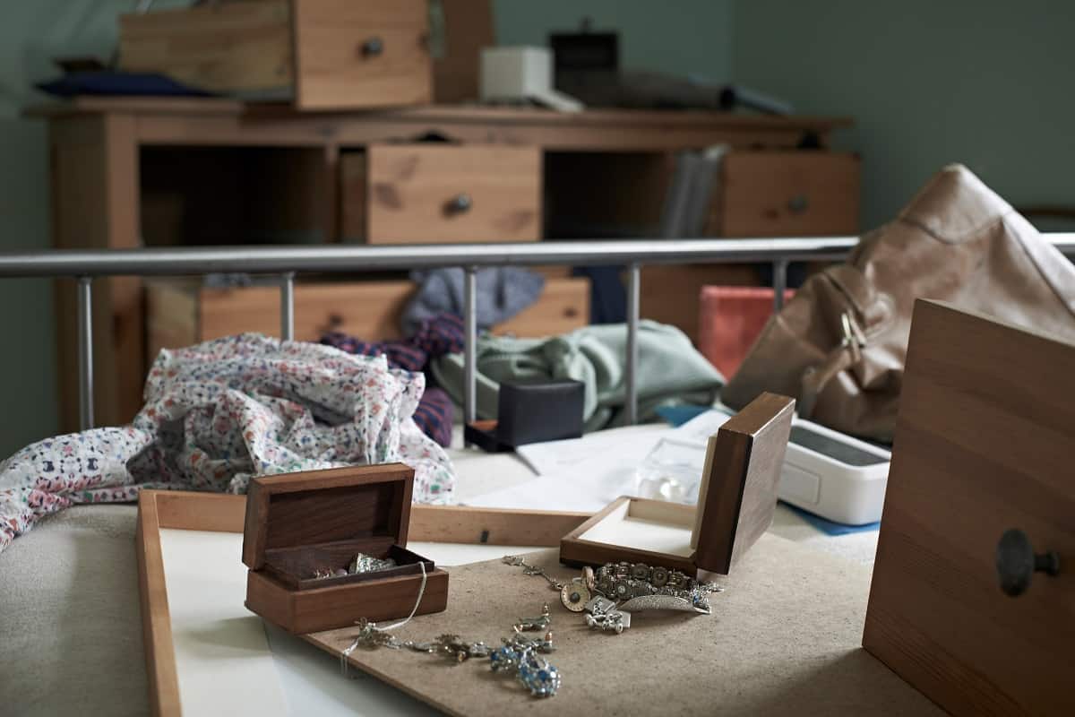 image of a ransacked bedroom with open jewelry boxes and open dresser drawers