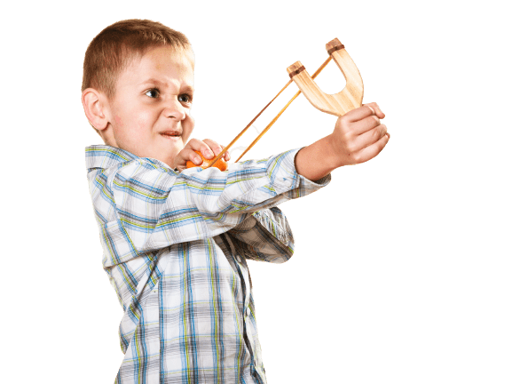 Boy launching fruit with slingshot