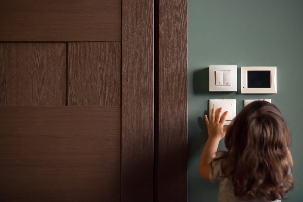 A child touching smart home controls