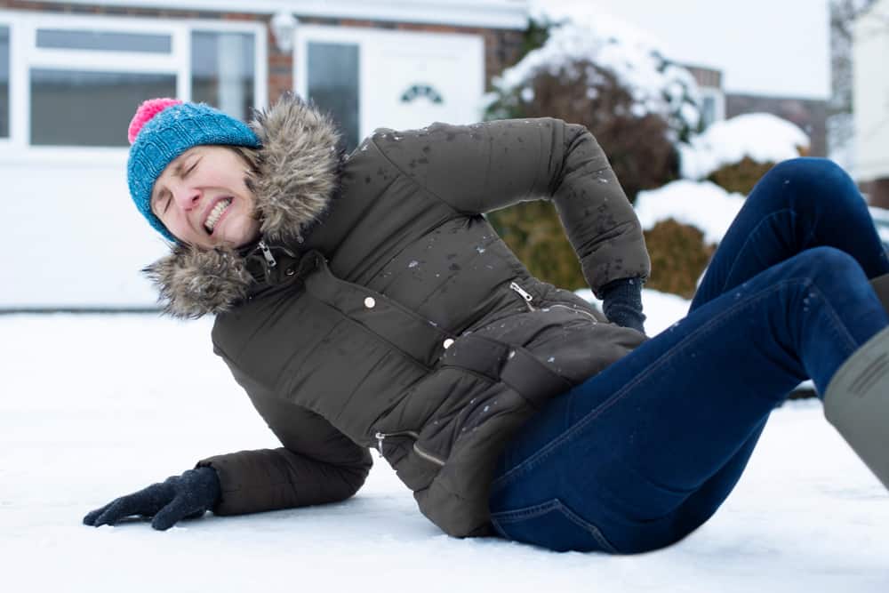 Woman in pain after slipping on ice