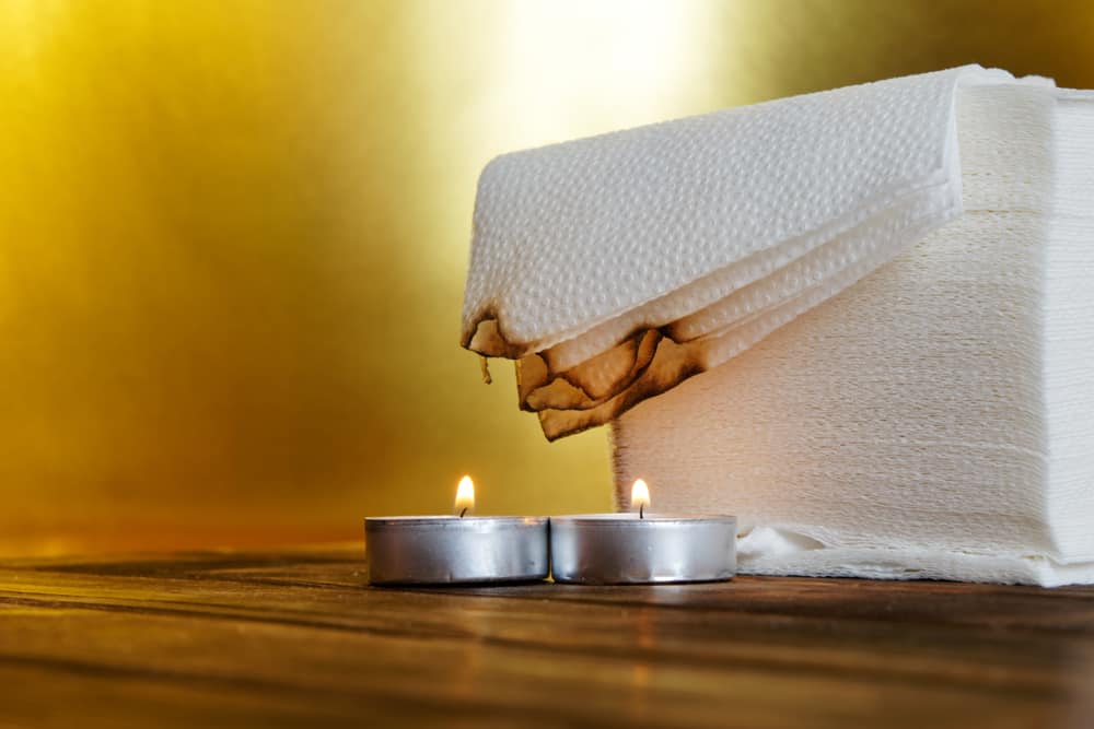 Napkins being burned by a candle