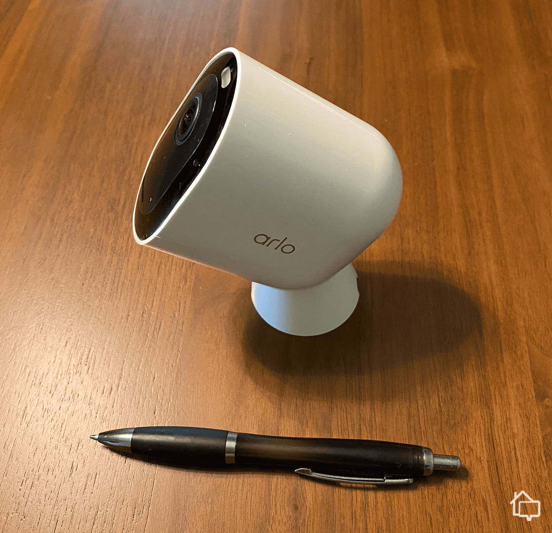The Arlo Pro 4 with a pen for scale