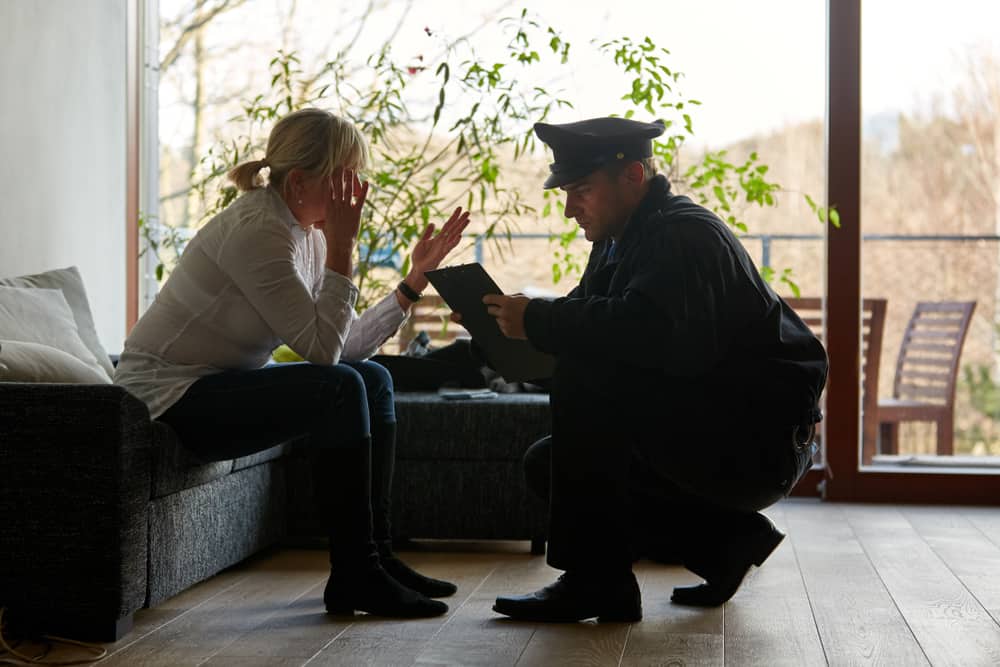 Psychologist of the police talking to a victim after a burglary with theft