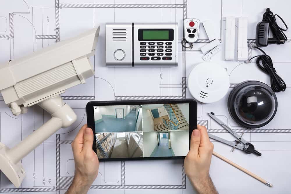 Close up of a person with a table and a security system