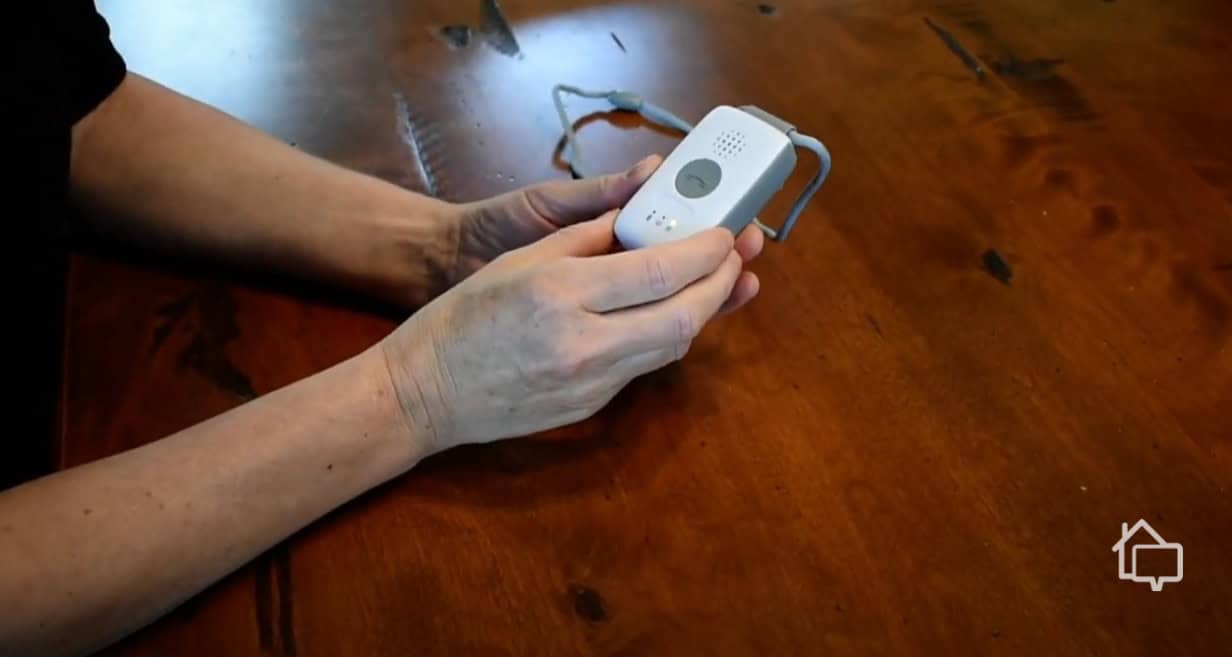 Our tester holding the MobileHelp Solo mobile base unit to test its responsiveness