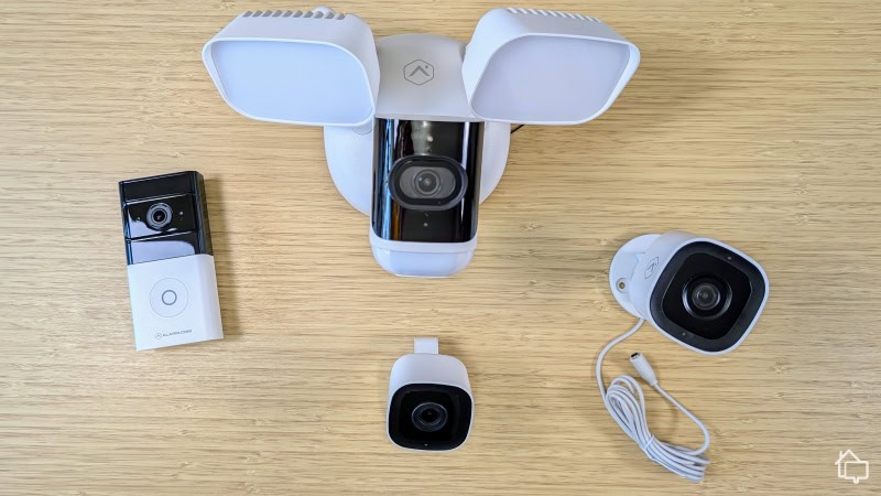 The four Frontpoint security cameras we tested: premium floodlight camera (top middle), outdoor camera (right), indoor camera (bottom middle) and wireless doorbell camera (left). 